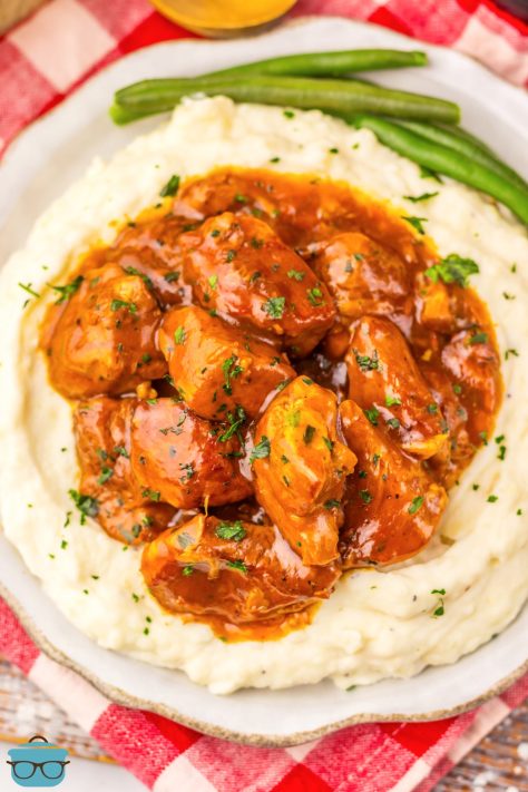 Looking down from above a plate of Slow Cooker Dr Pepper Rib Bites on a mountain of mashed potatoes.