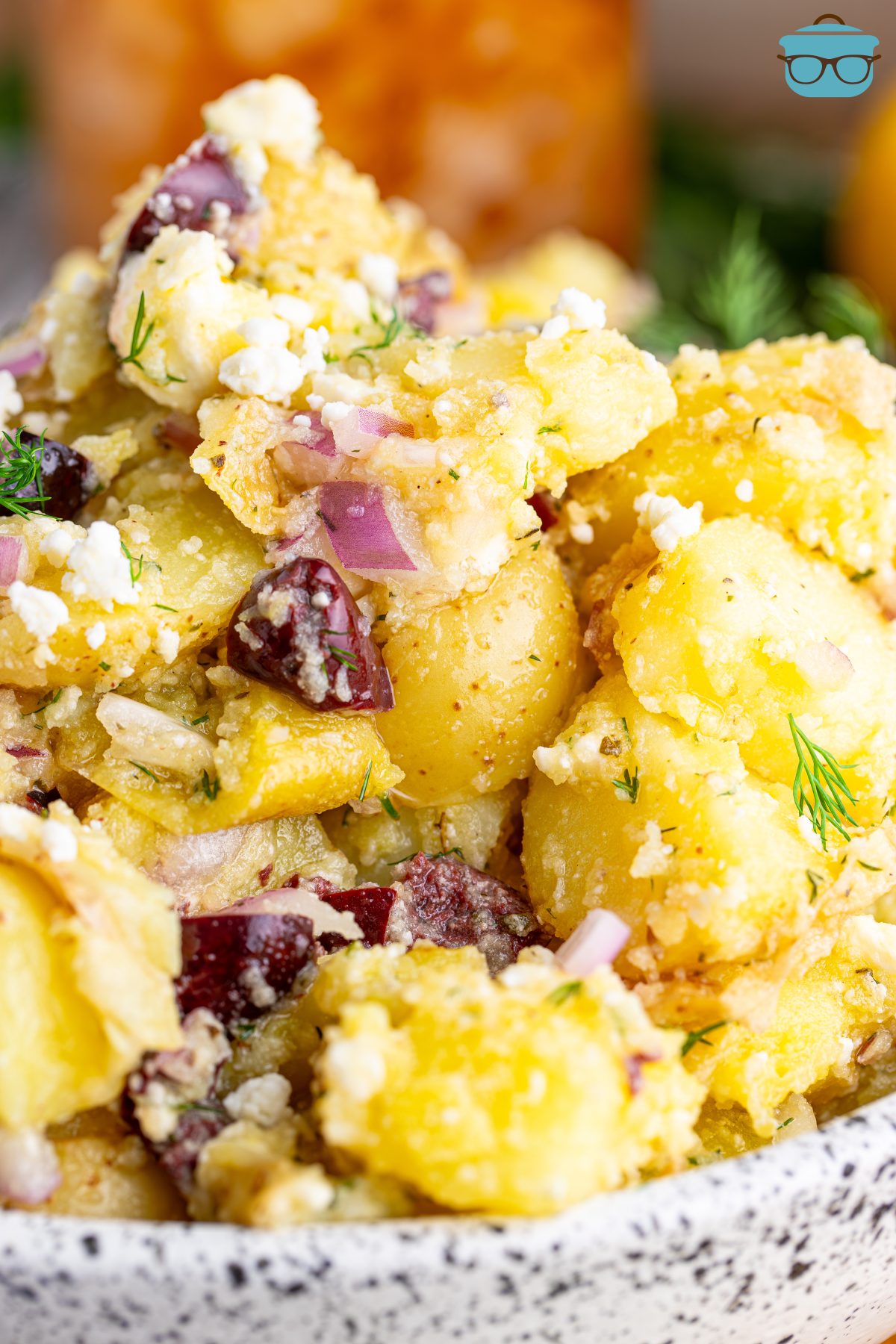 Close up looking at a scoop of Greek Potato Salad.