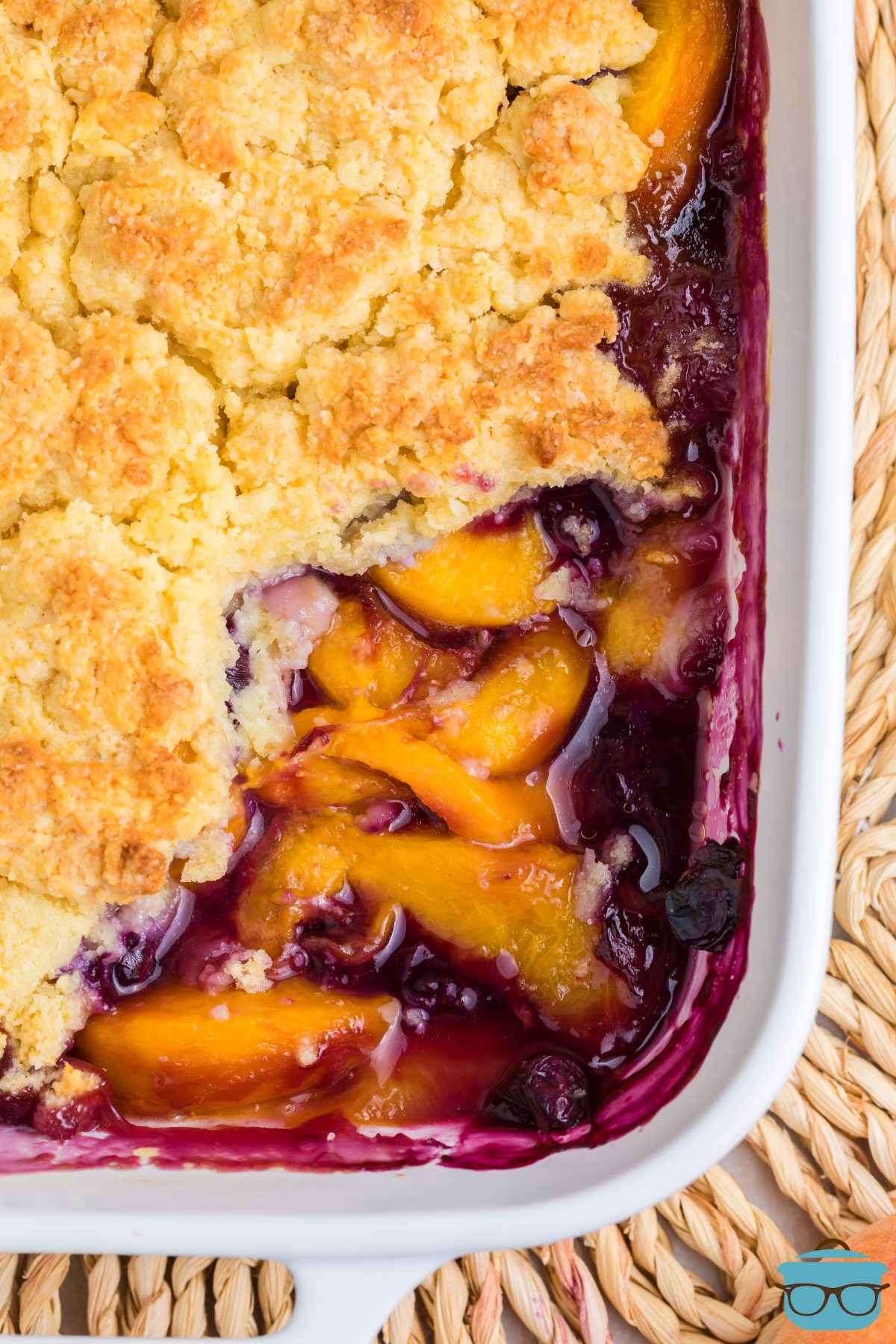 Looking down on the bottom corner of a pan of Peach Blueberry Cobbler.