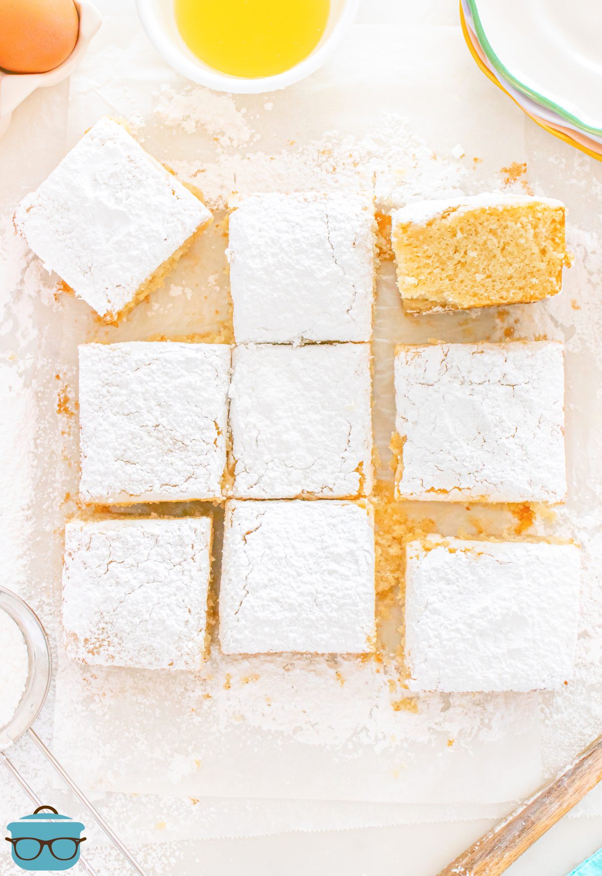Looking down on a few slices of Powdered Sugar Donut Snack Cake.