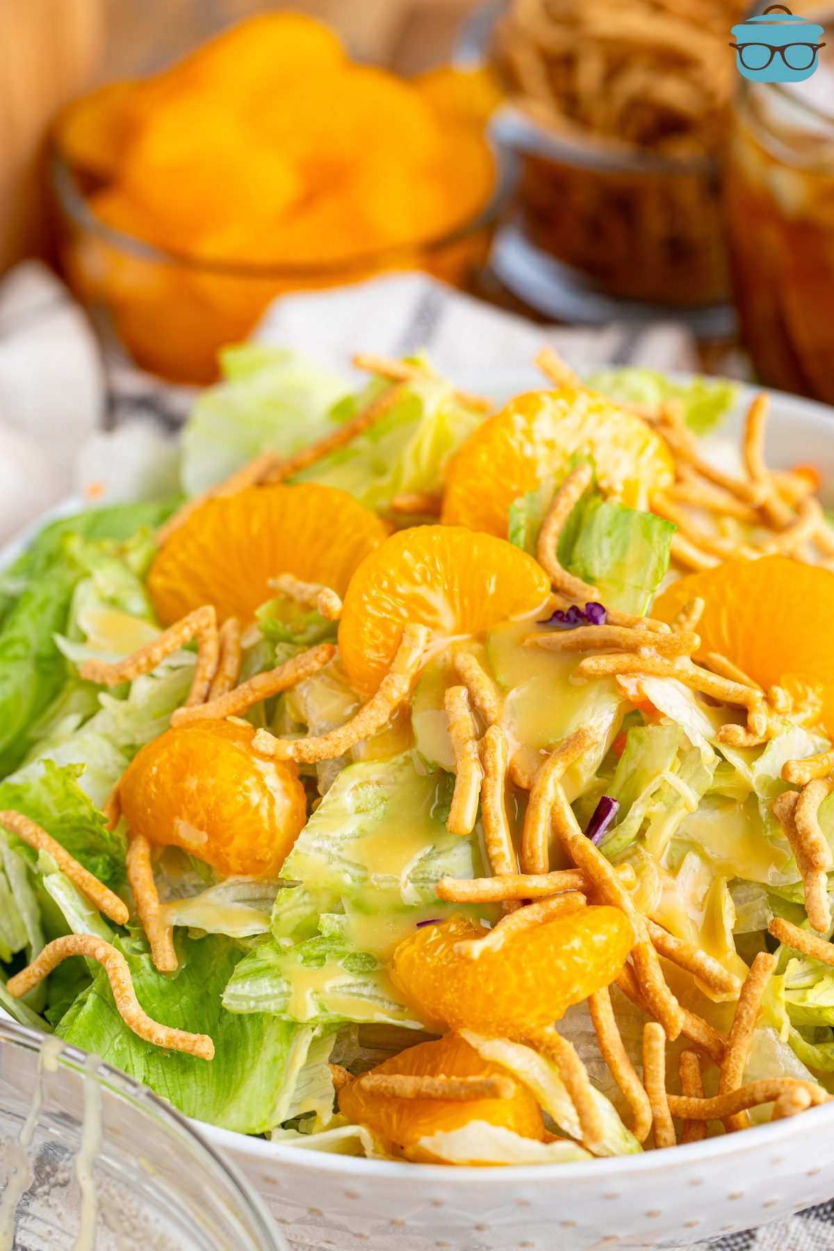 A bowl of salad with mandarin oranges and Teriyaki Salad Dressing.