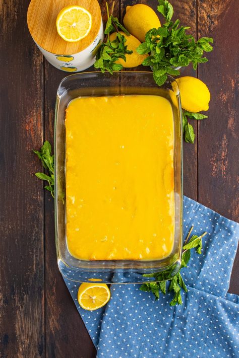 Lemon glaze over cookie bars.
