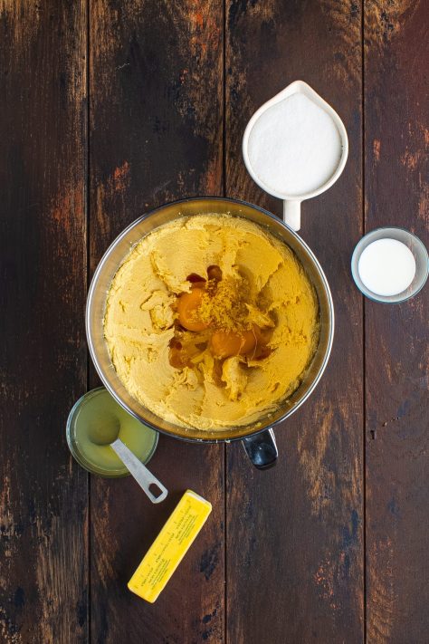 Eggs, lemon juice, lemon zest, and vanilla added to a creamed butter mixture.