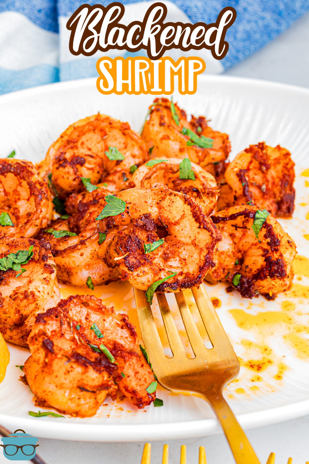 A fork getting some Blackened Shrimp from the plate. 