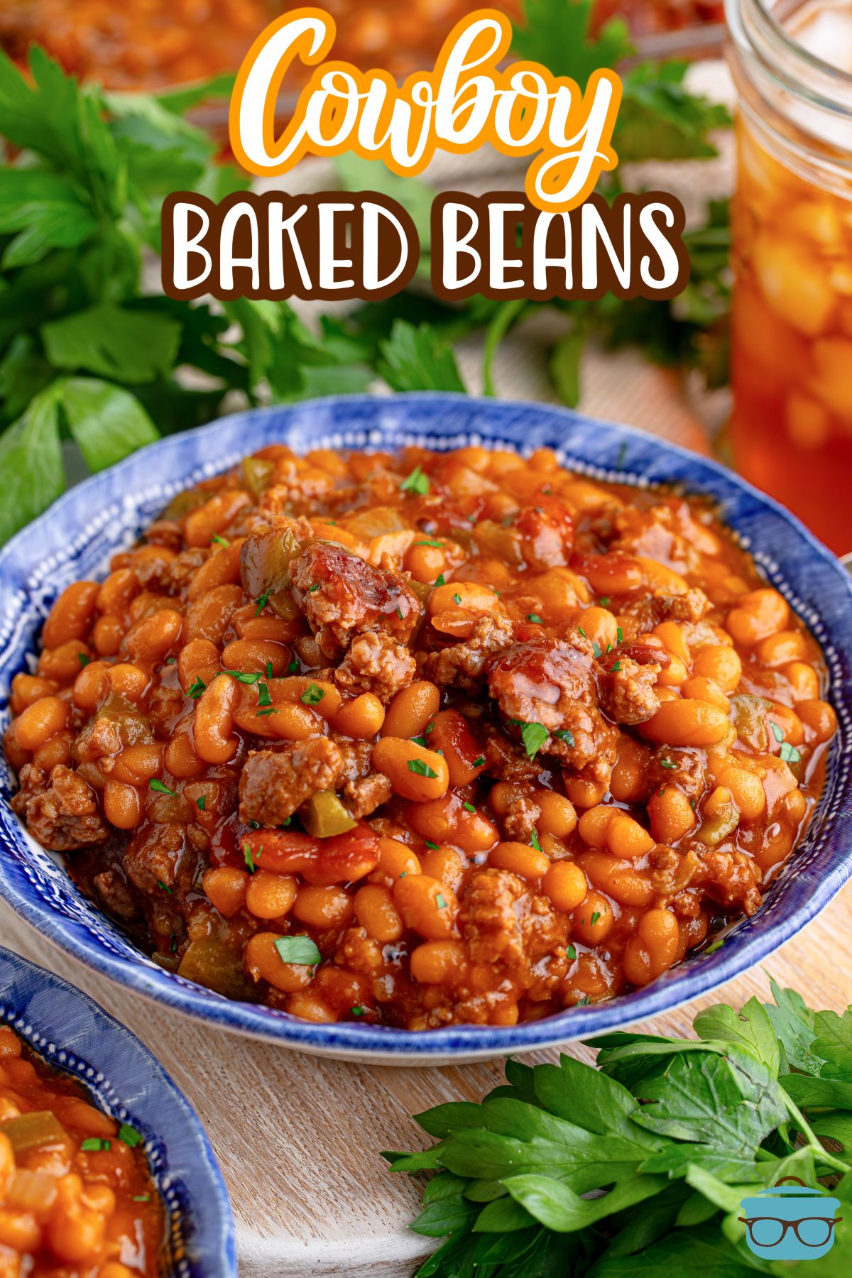 A big blue serving dish of Cowboy Baked Beans.