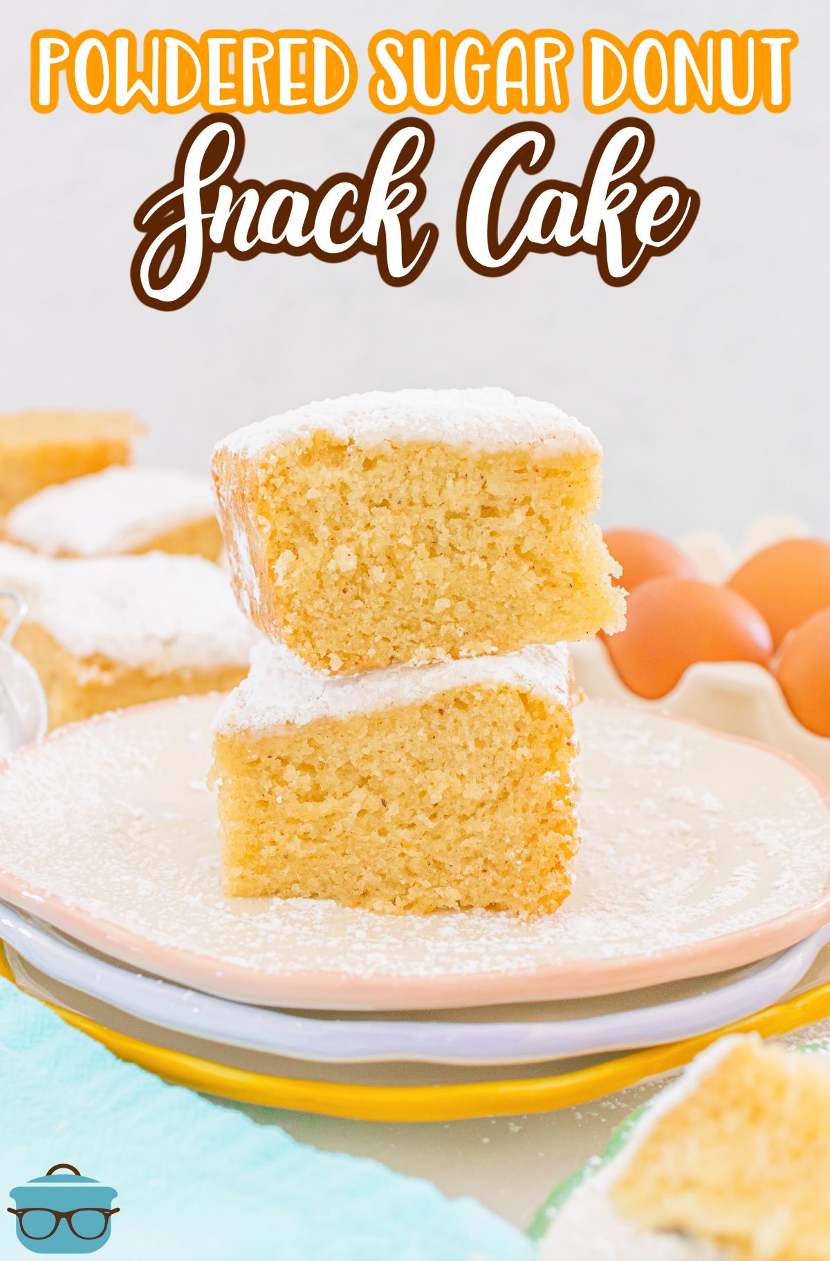 A few slices of Powdered Sugar Donut Cake on top of each other on a dessert plate.