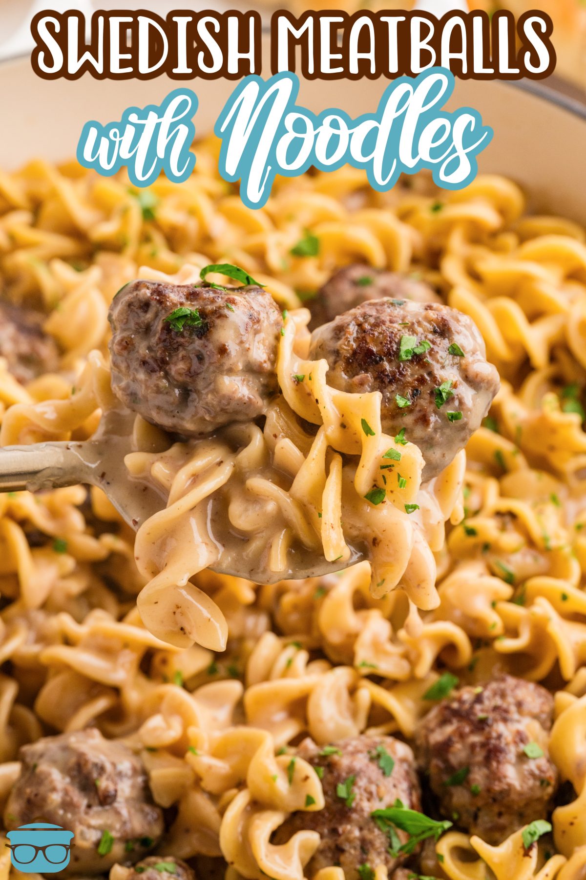 A big dish of Swedish Meatballs with Noodles and a spoon scooping some up.