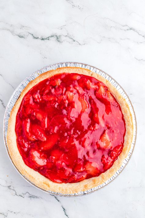 A baked pie crust with strawberry filling.