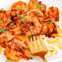 A fork getting a bite from the pile of Blackened Shrimp.