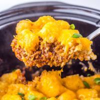 A serving utensil getting a scoop of Crock Pot Chili Cheese Tater Tot Casserole from the Slow Cooker.