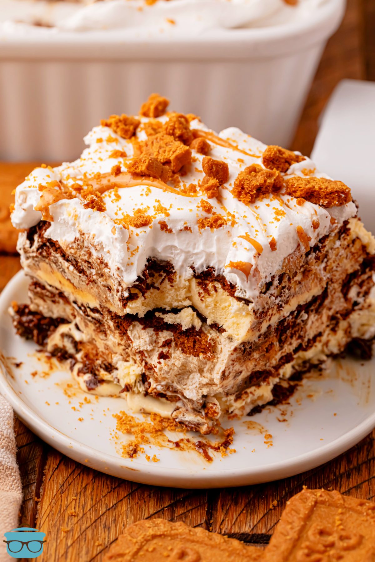 A plate with a large slice of Biscoff Ice Cream Sandwich Cake and a bite missing from the corner. 