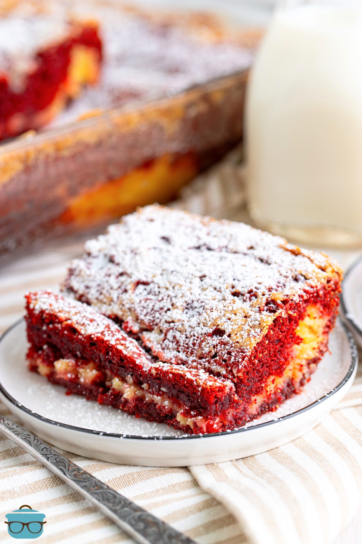 A square slice of Red Velvet Gooey Butter Cake on a plate.