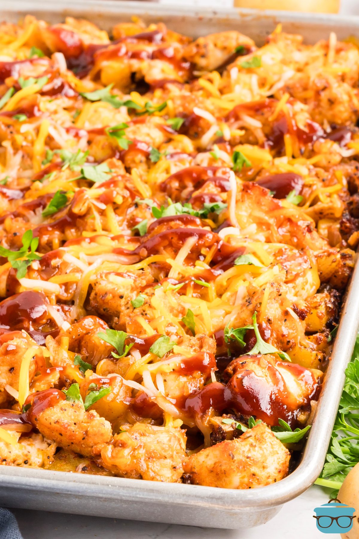 A full baking sheet with Sheet Pan BBQ Chicken and Potatoes.