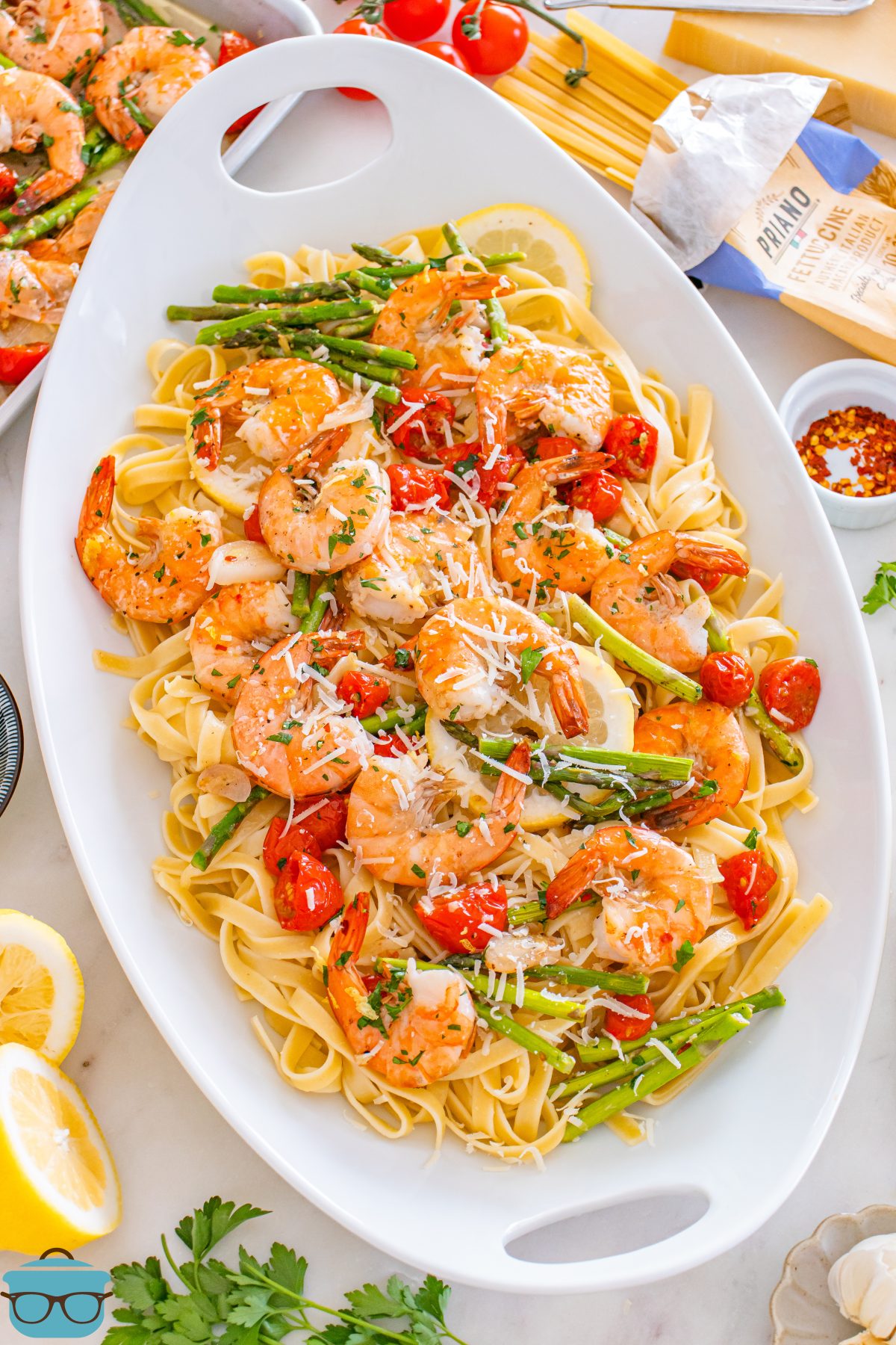 A large white serving dish with Sheet Pan Shrimp Scampi.