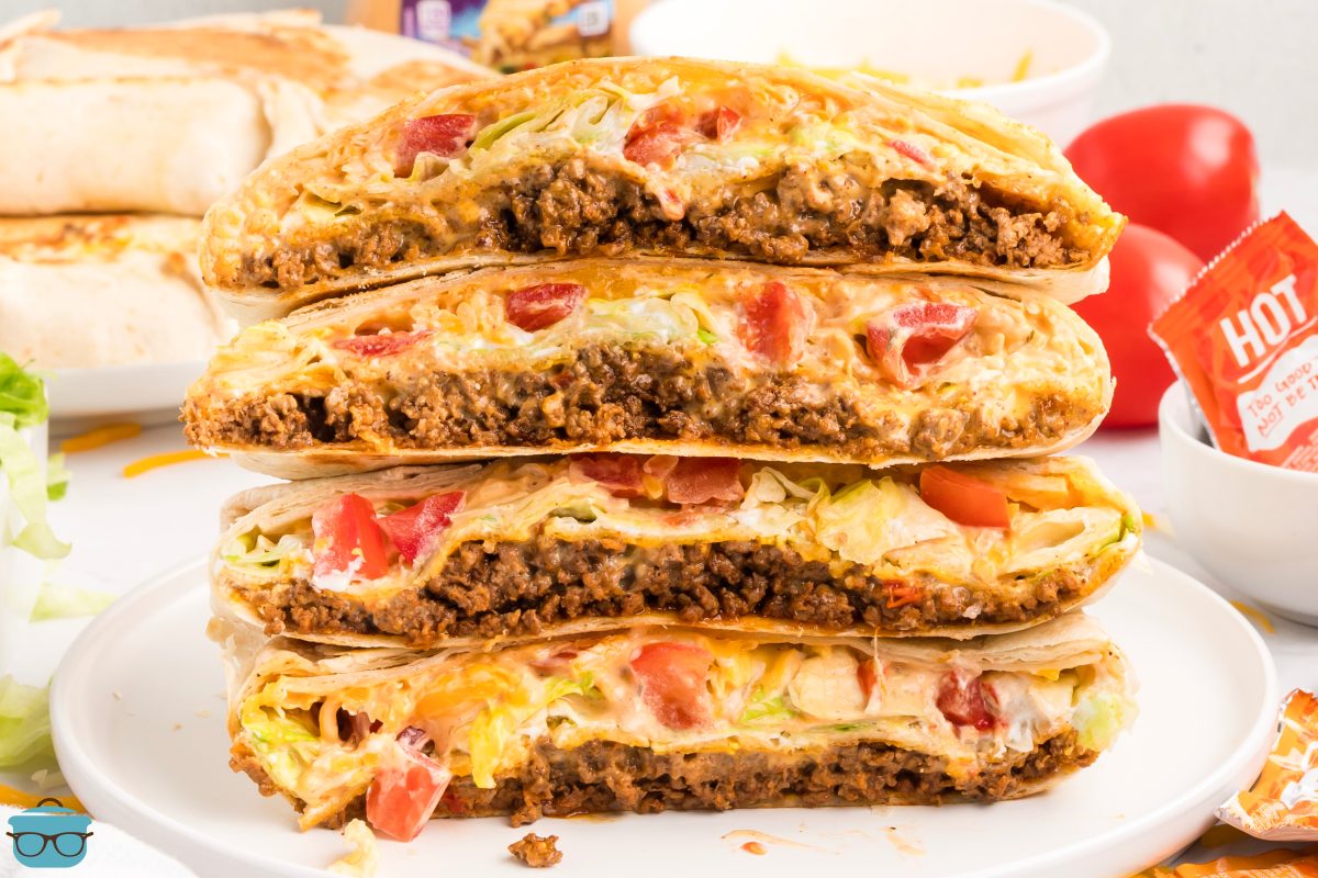 A plate with a small stack of open Taco Bell Crunchwrap Supremes.