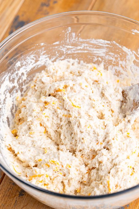Biscuit dough being mixed in a bowl.