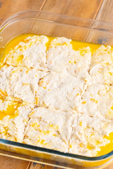 Cut dough in butter in a glass dish.