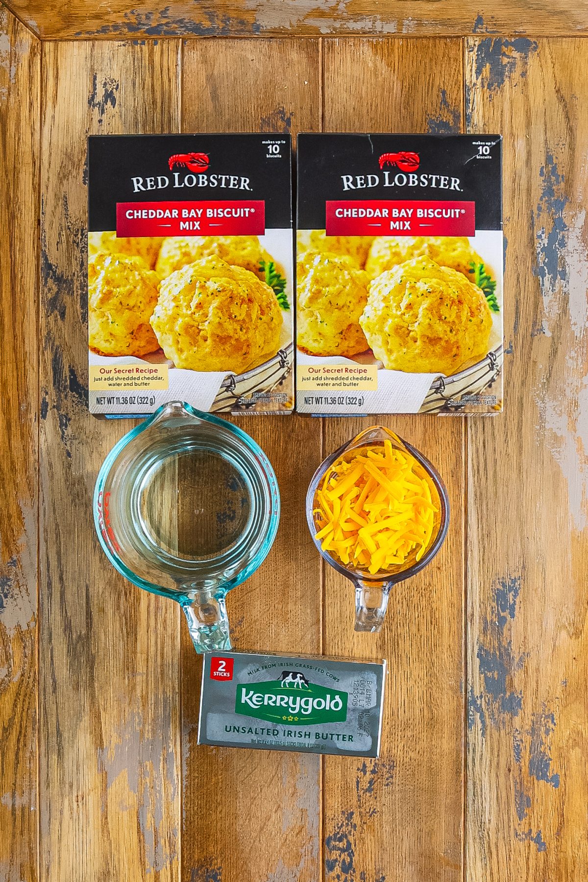 Cheddar Bay Biscuit mix and packets, cheddar cheese, water, and butter.