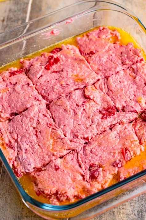Melted butter and biscuit dough in a baking dish.
