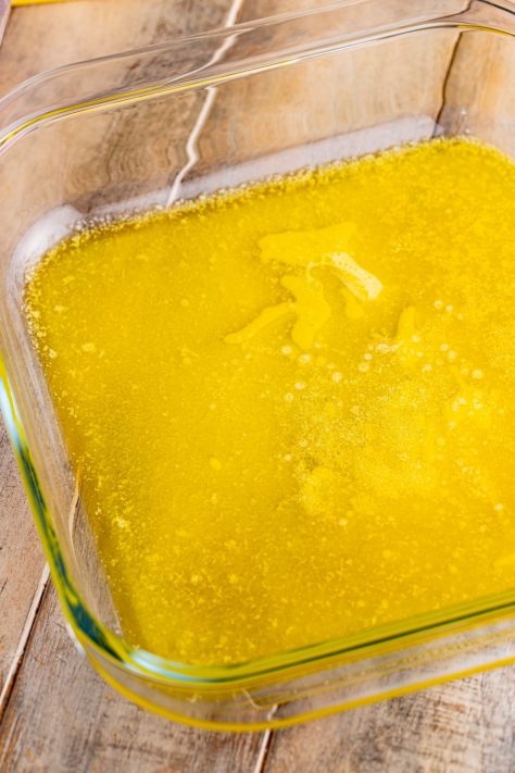 Melted butter in a baking dish.