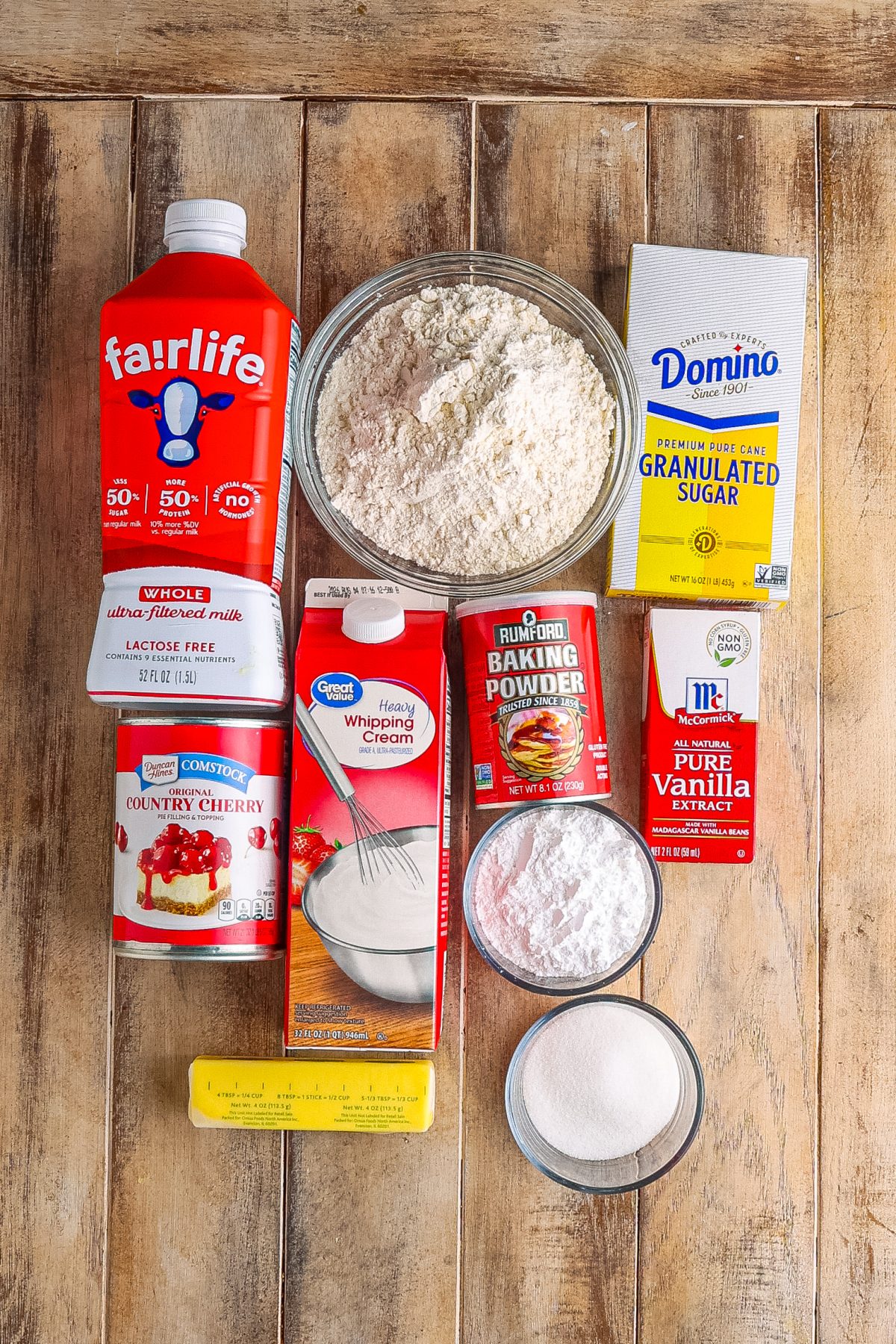 All-purpose flour, granulated sugar, baking powder, cherry pie filling, heavy cream, vanilla extract, salted butter, powdered sugar, and milk.