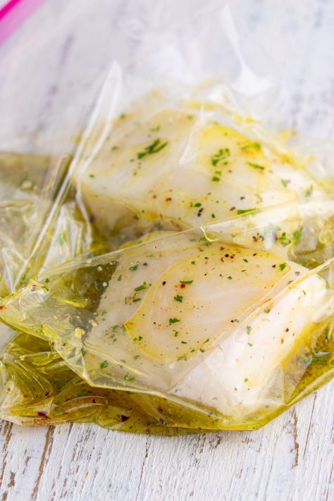 Sea Bass filets in a marinade in a bag.
