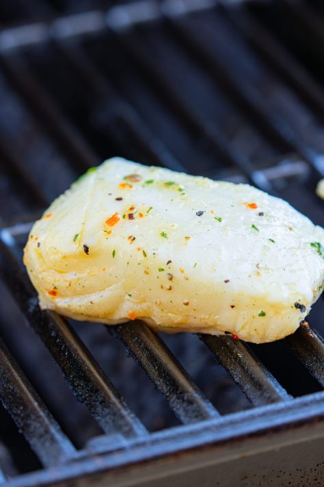 A piece of Sea Bass sitting on the grill.