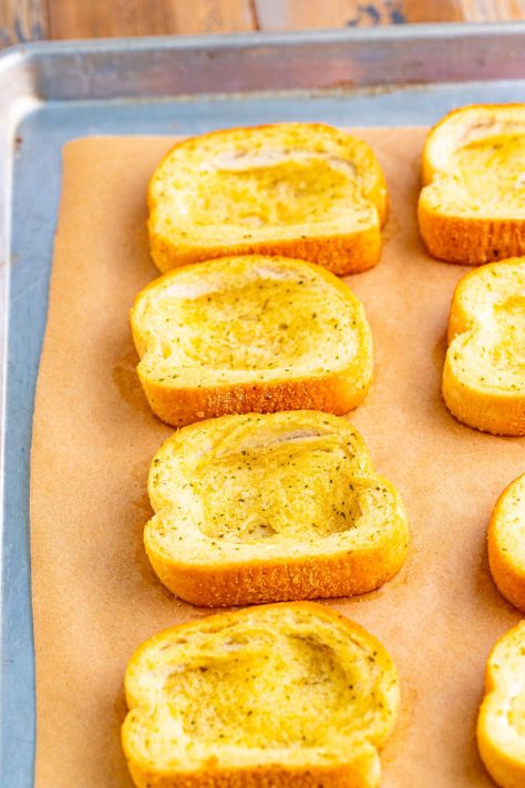 Wells being made on pieces of Texas Toast.