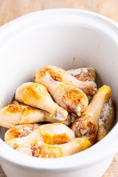 Seared chicken legs in a Slow Cooker.