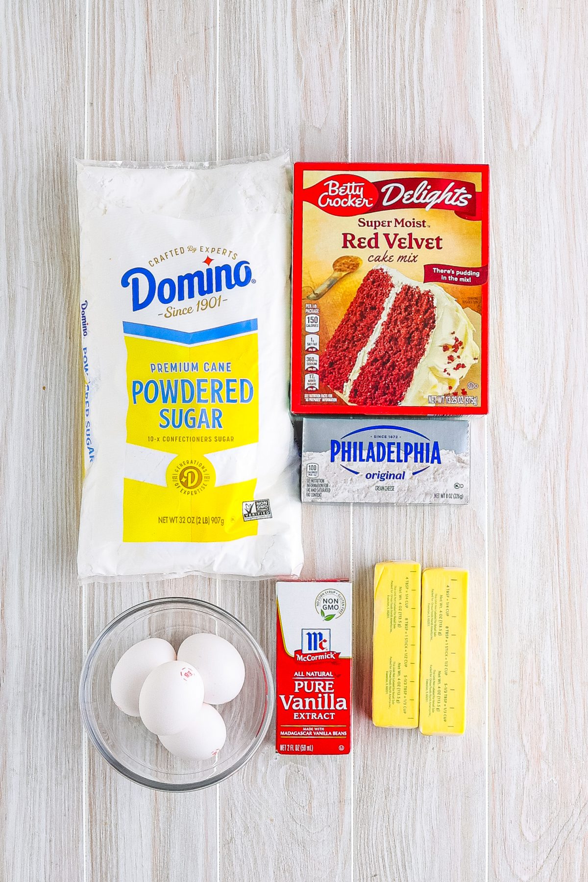 Red velvet cake mix, powdered sugar, cream cheese, eggs, vanilla, and butter.