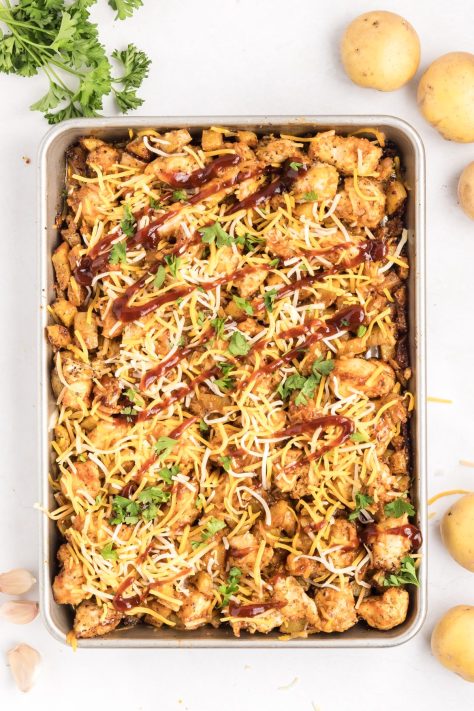 Barbecue chicken and potatoes on a sheet pan.