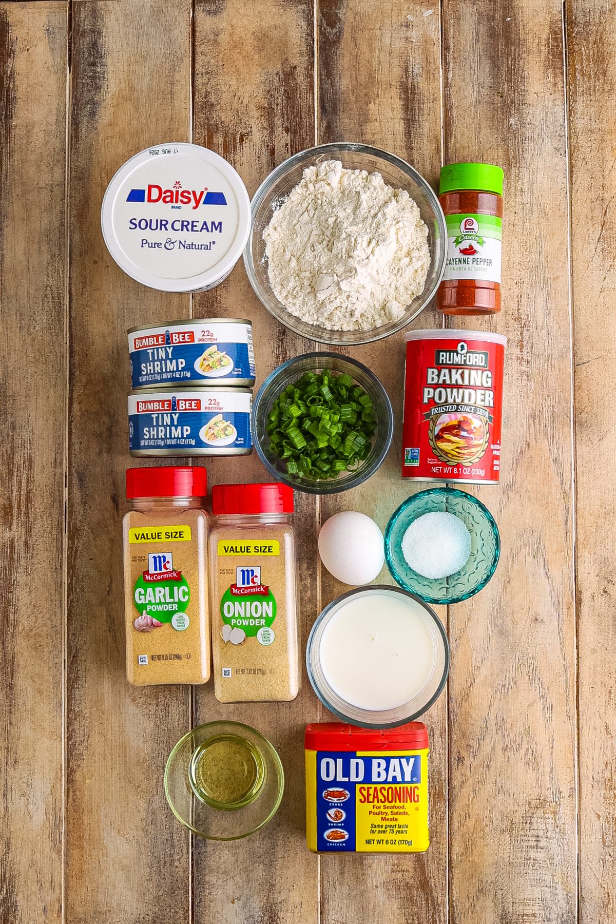 All-purpose flour, baking powder, sugar, Old Bay seasoning, garlic powder, onion powder, cayenne pepper, milk, sour cream, vegetable oil, egg, shrimp, and green onions.