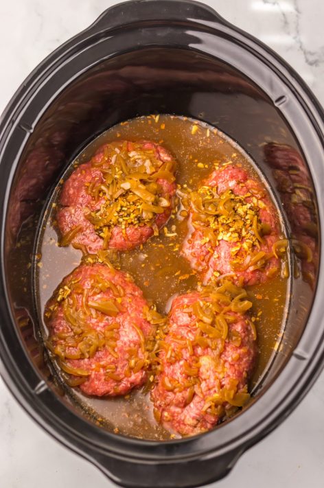 Raw Salisbury Steak patties with French Onion soup mix and soup in a Slow Cooker.