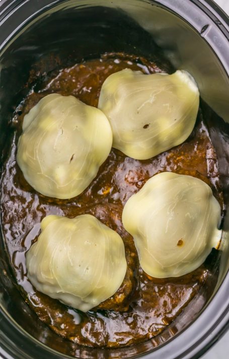 A Slow Cooker with 4 French Onion Salisbury Steaks.