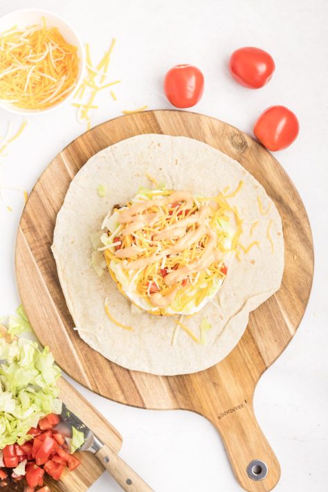 Crunchwrap supreme being assembled.
