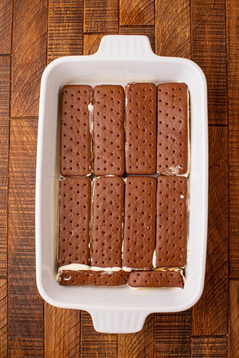 A baking dish with a layer of ice cream sandwiches.