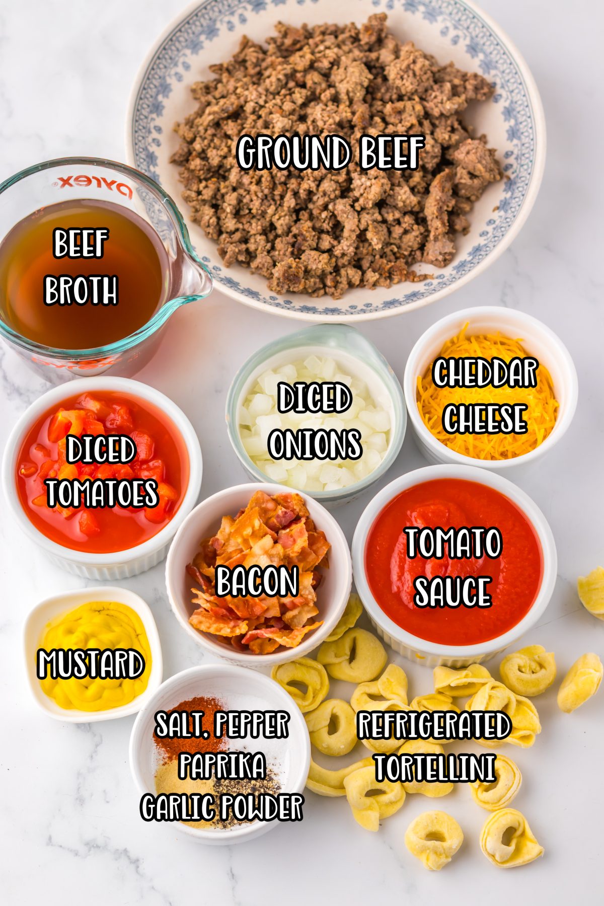 Ground beef, diced onion, salt, black pepper, garlic powder, paprika, bacon, diced tomatoes, beef broth, tomato sauce, yellow mustard, refrigerated cheese tortellini, and shredded cheddar cheese.