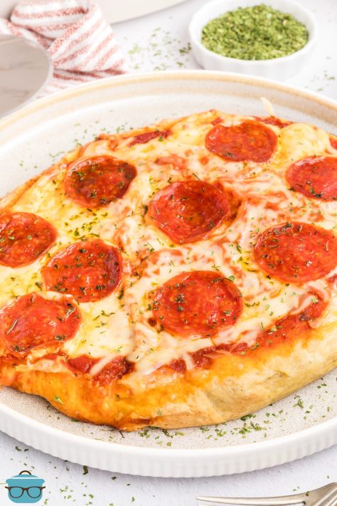 A pizza plate with a Deep Dish Pizza on it.