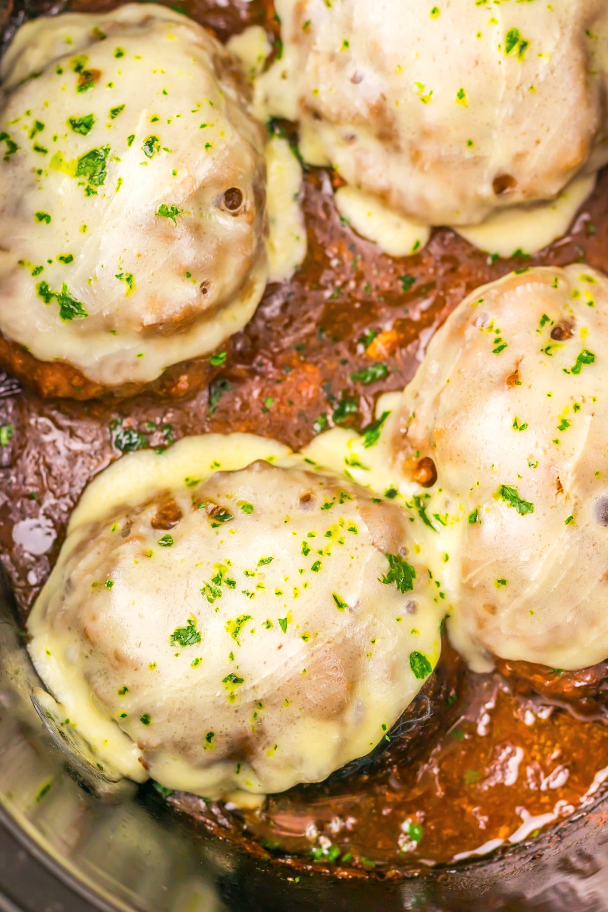 Four large French Onion Salisbury Steaks in the Slow Cooker.