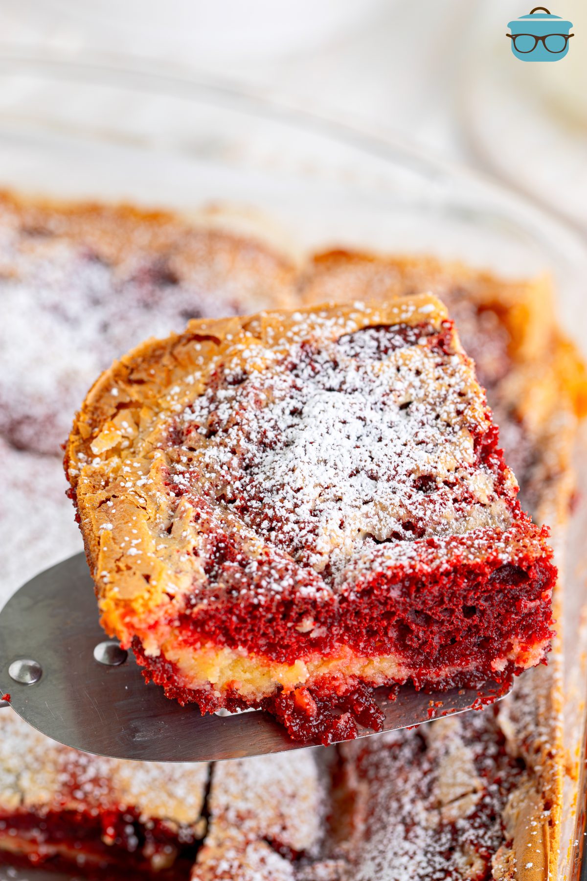 A corner piece of Red Velvet Gooey Butter Cake.