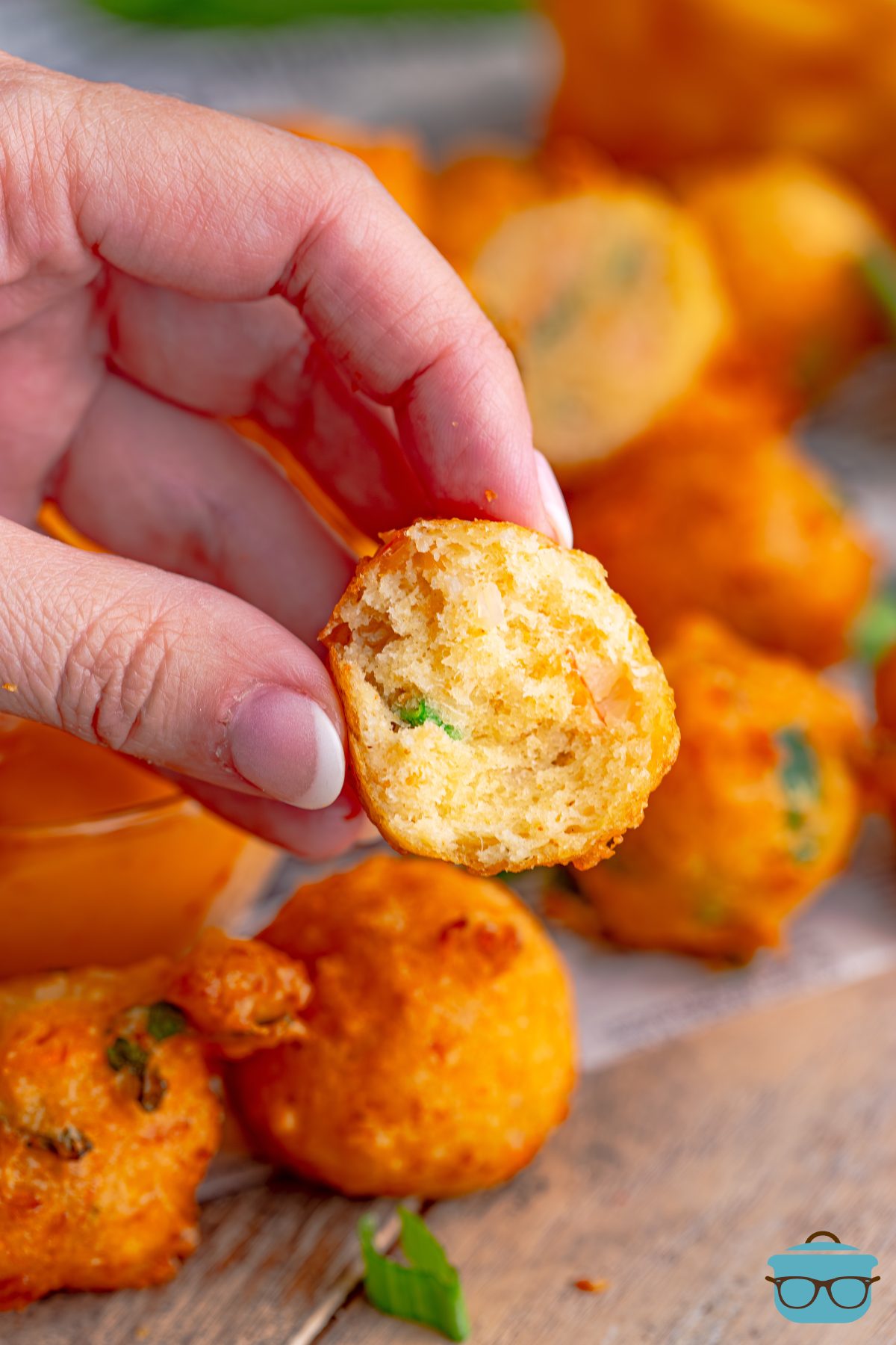 A hand holding a Shrimp Fritter.