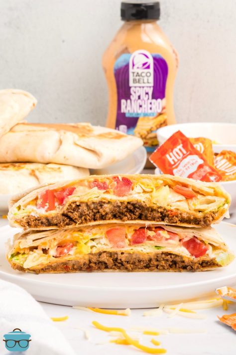 An open faced Crunchwrap Supreme on a serving plate.