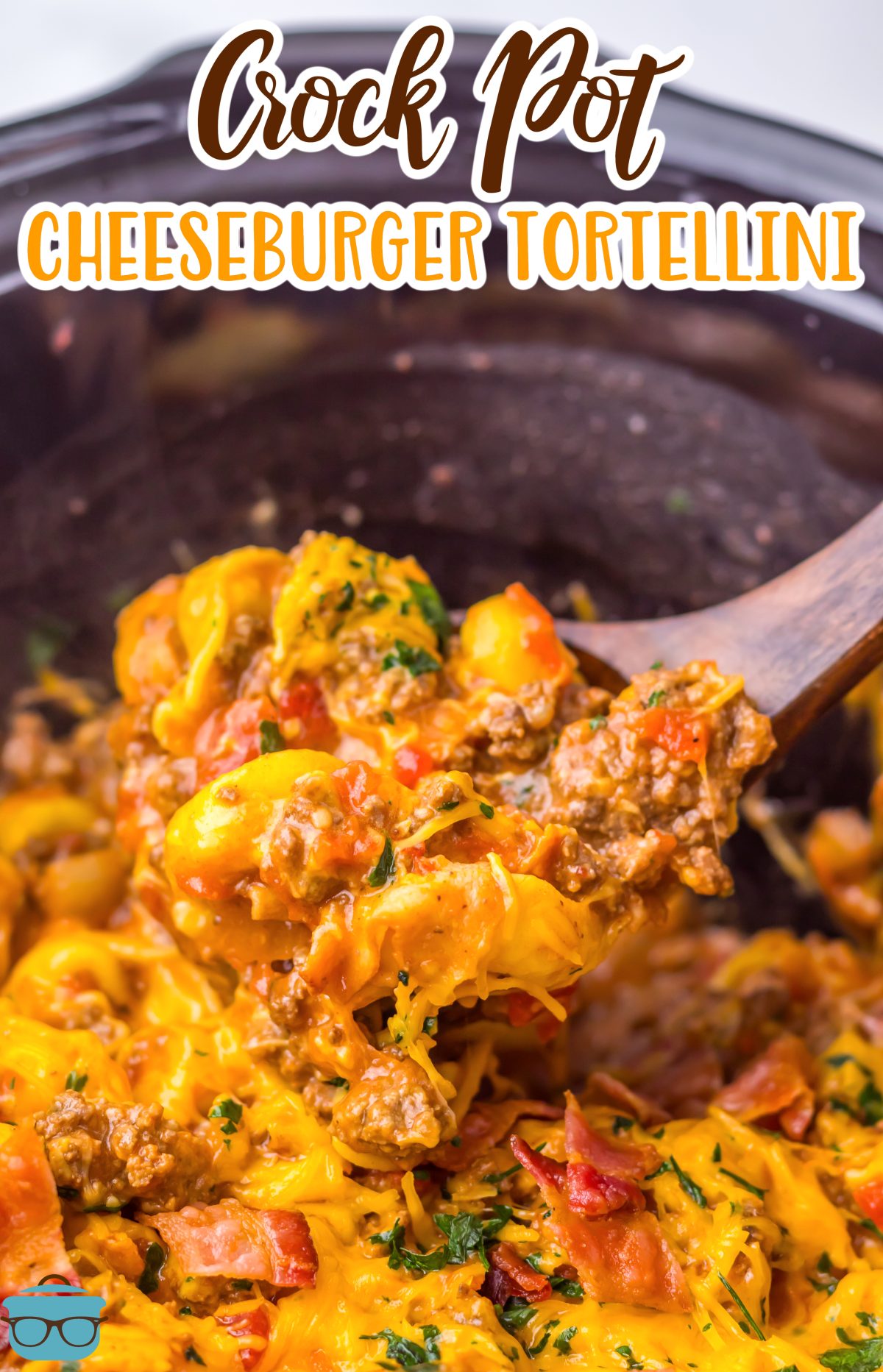 A wooden serving utensil getting some Cheeseburger Tortellini from the Slow Cooker. 