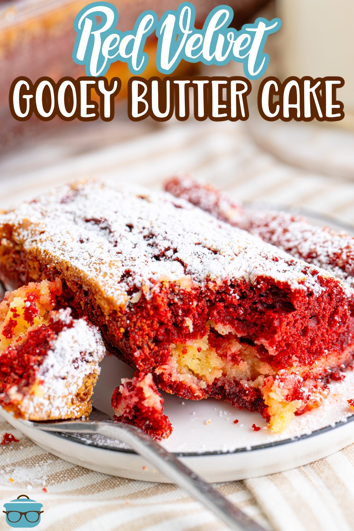 A slice of Red Velvet Gooey Butter Cake with a bite sitting on a fork.